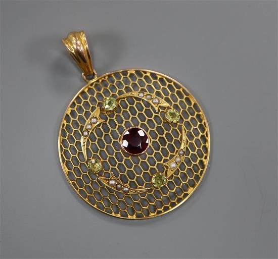 A late Victorian 9ct circular pierced pendant, set with split pearls, peridot and a central amethyst, 32mm.